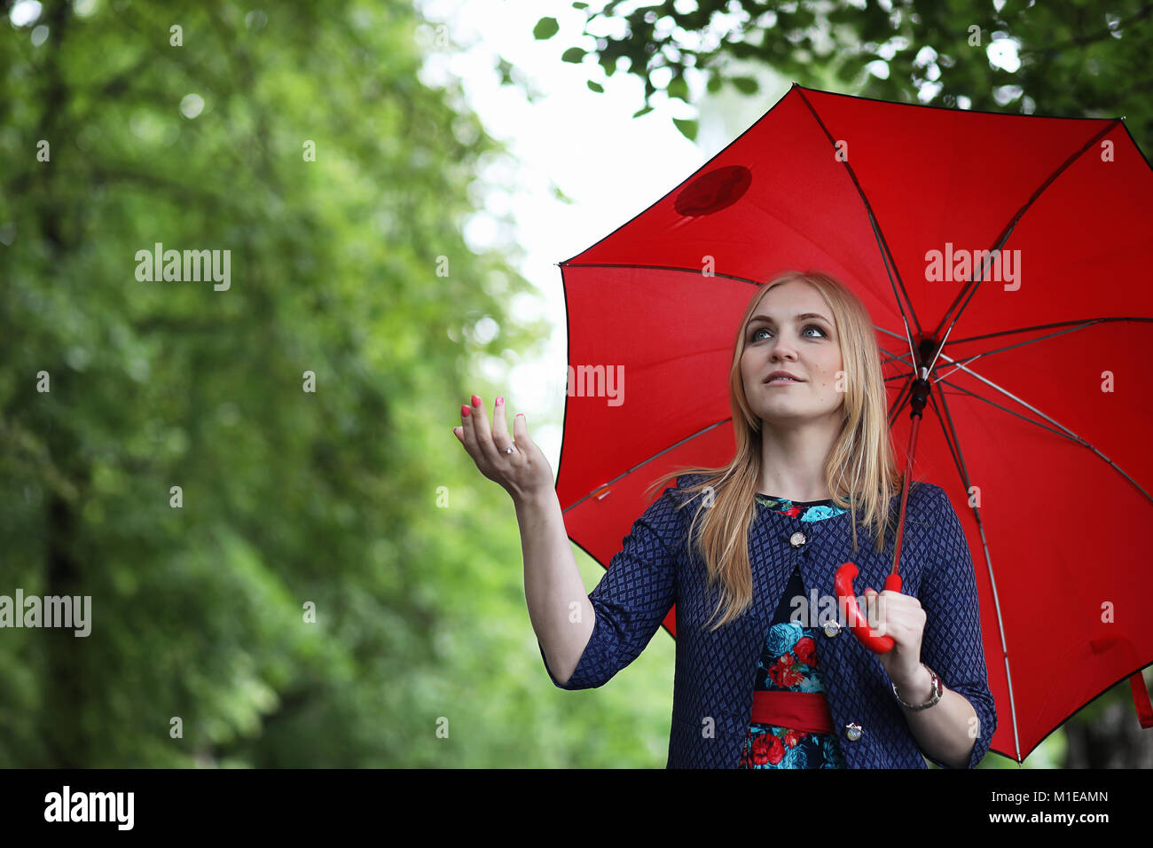 Girl in the street with an umbrella Stock Photo - Alamy