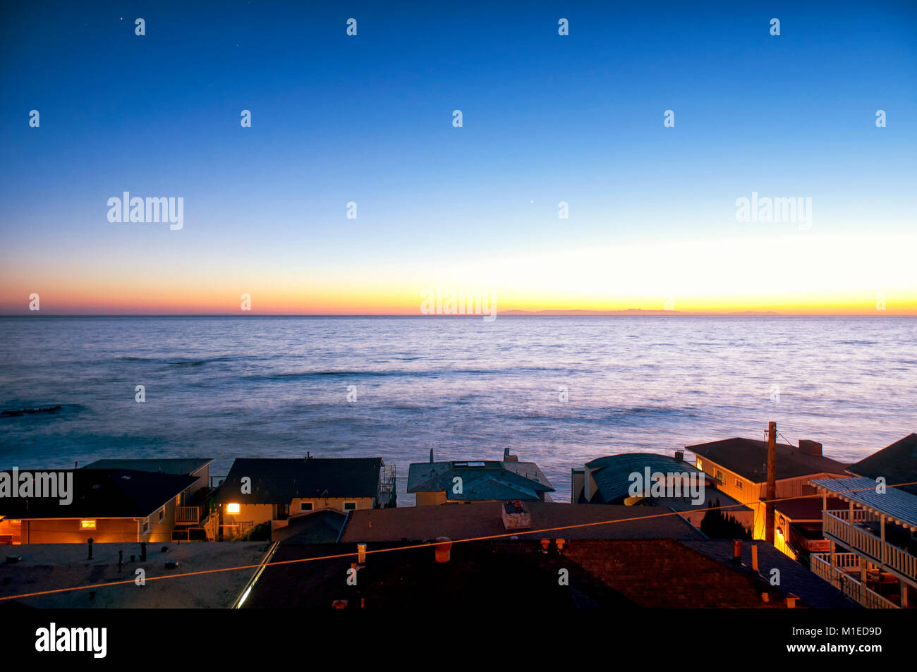 Expensive homes lining Laguna Beach California as the sun is setting