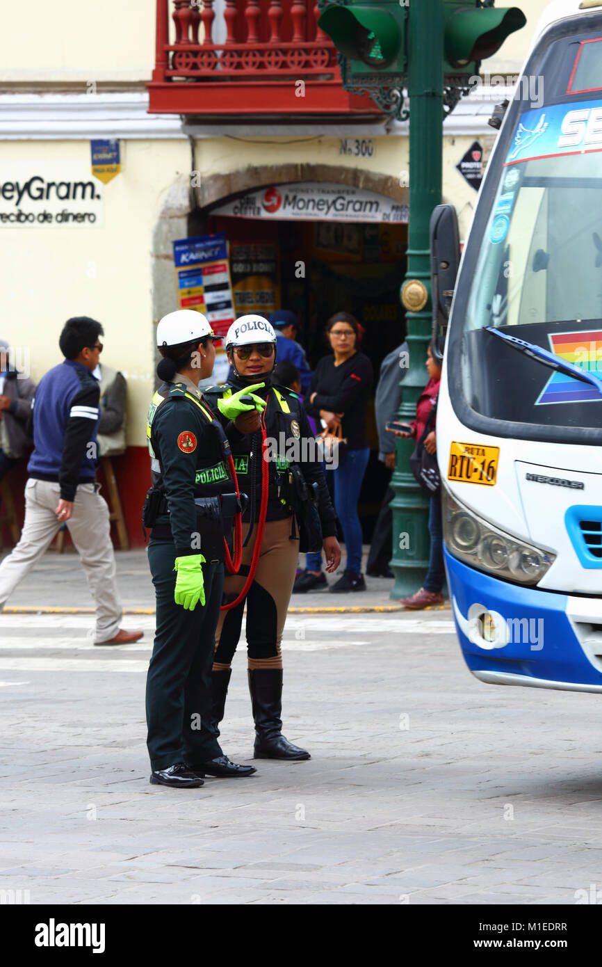 Policewomen directing traffic in Avenida del Sol, Cusco, Peru Stock Photo