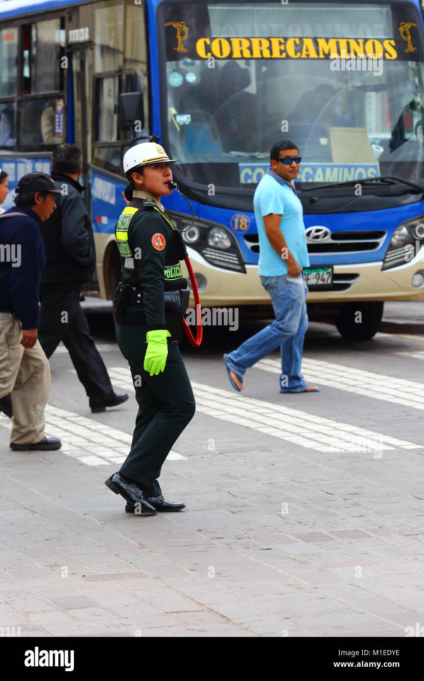 Policewoman directing traffic in Avenida del Sol, Cusco, Peru Stock Photo