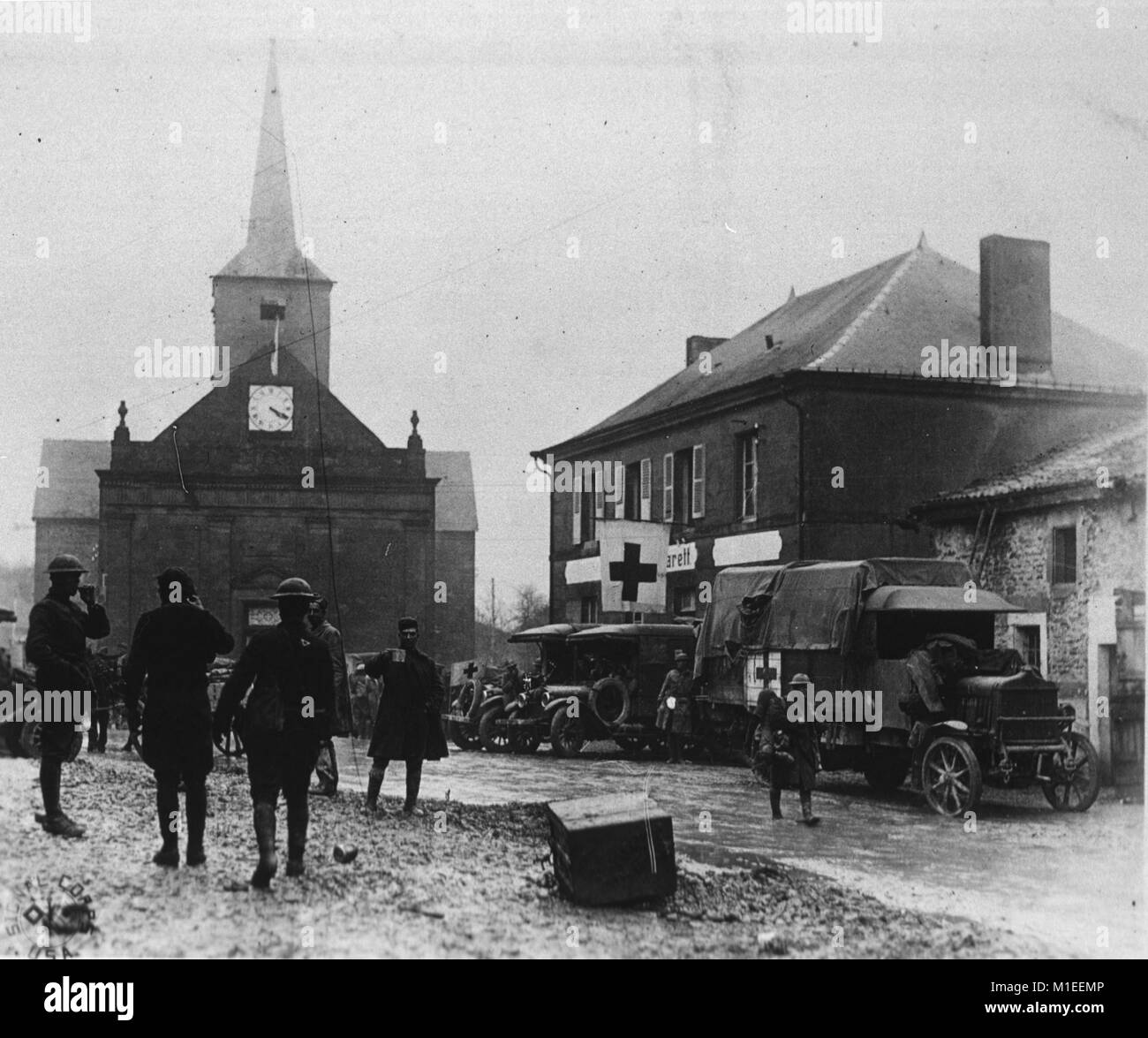 Soldiers walking on street with military medical trucks parked in background, France, January 19, 1945. Courtesy National Library of Medicine. () Stock Photo