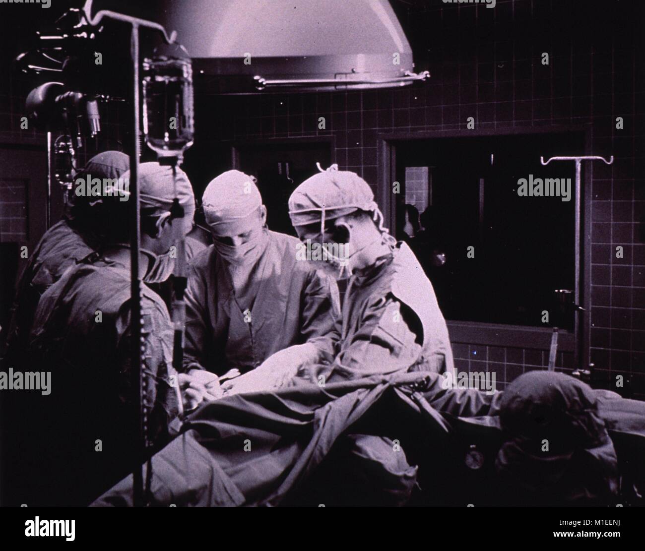Group of doctors proceeding surgery in operating room, 1955. Courtesy National Library of Medicine. () Stock Photo