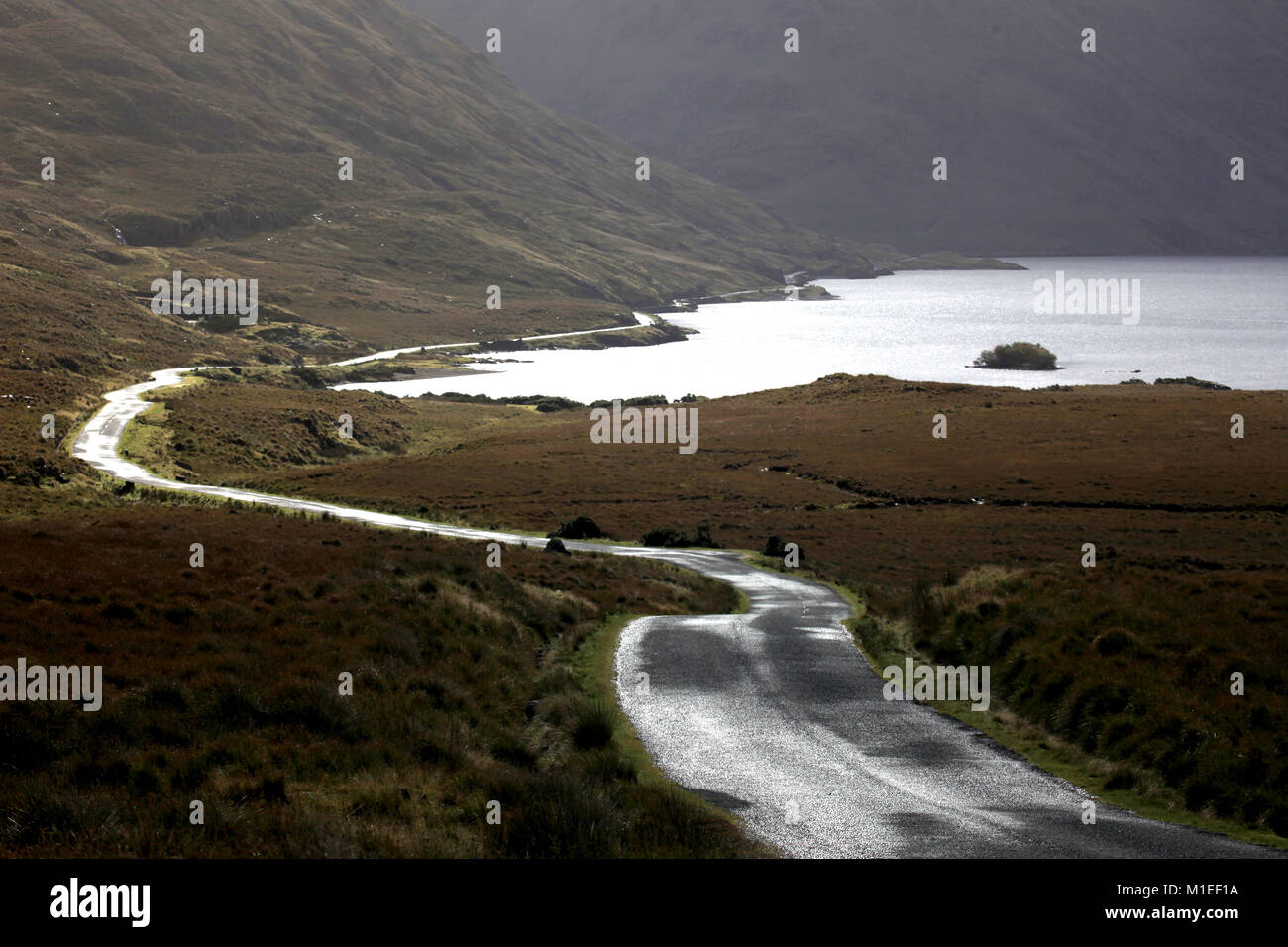 rural roadway winding along an irish inland lake wild atlantic way,  co mayo ireland, Stock Photo