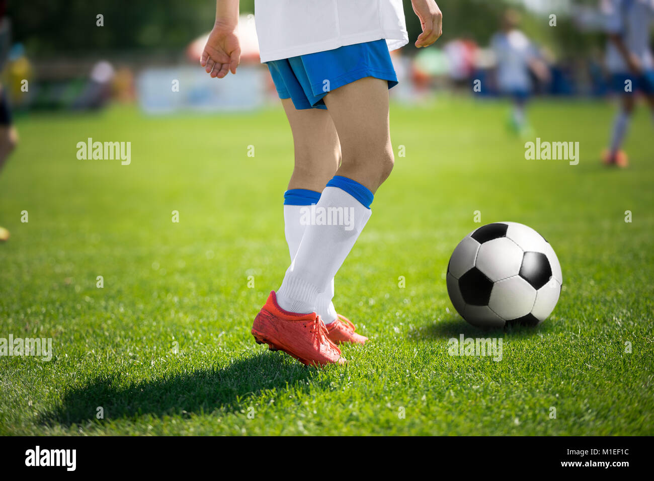 Feet of football player with soccer ball. Soccer players before kick
