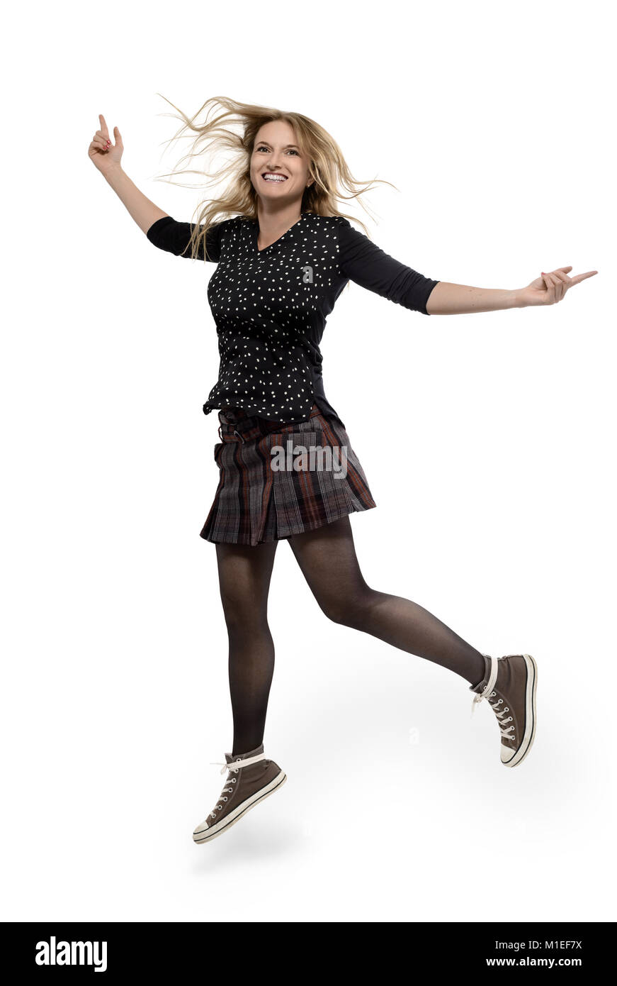 Young woman  mini skirt jumping Stock Photo