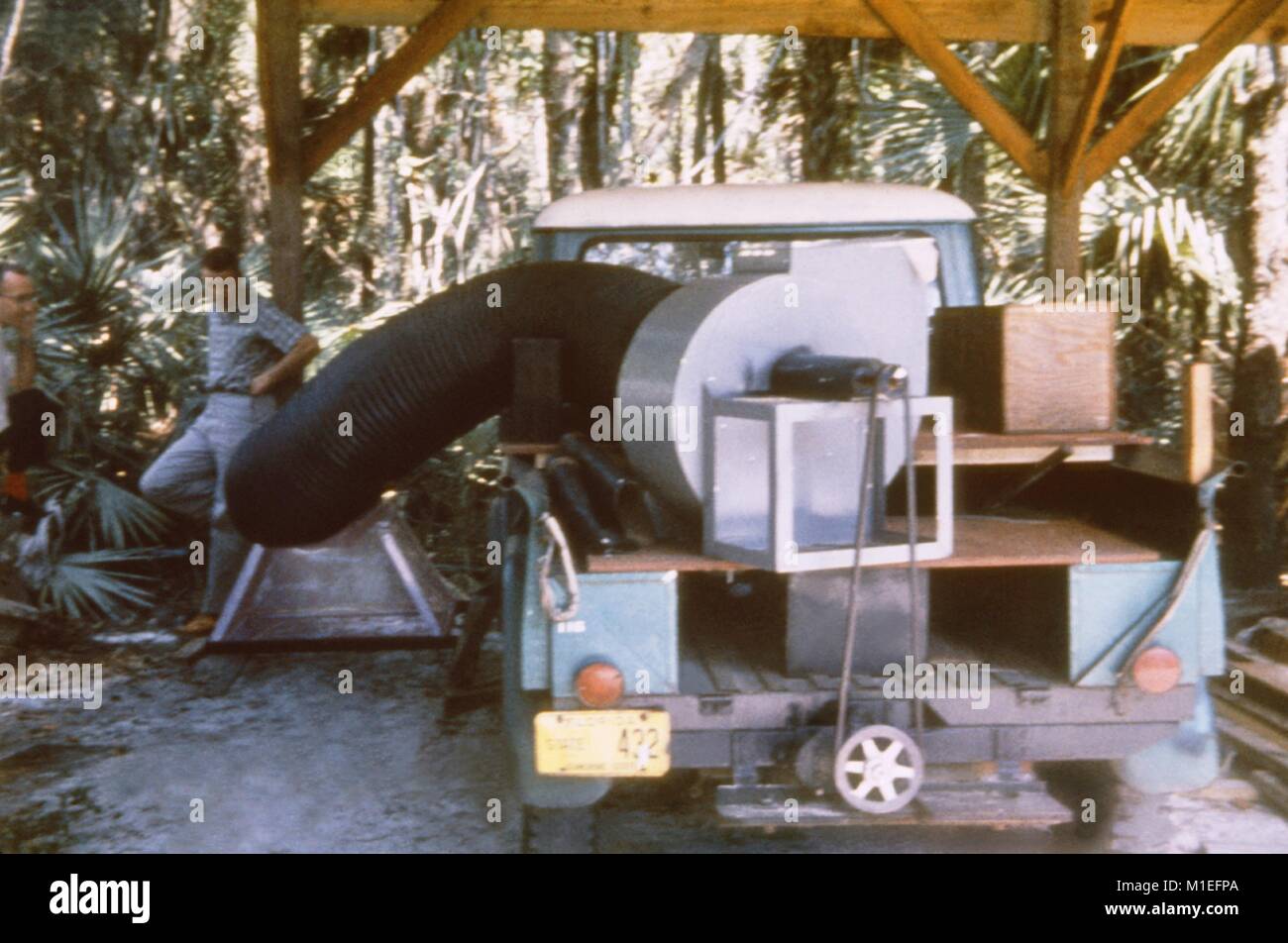 Giant mosquito vacuum mounted on a truck collecting mosquitoes, 1965