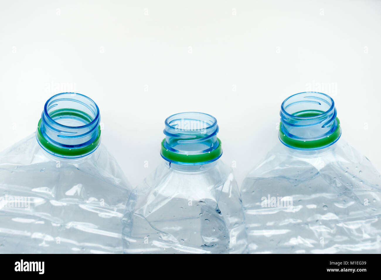 Three empty crushed plastic water bottles Stock Photo