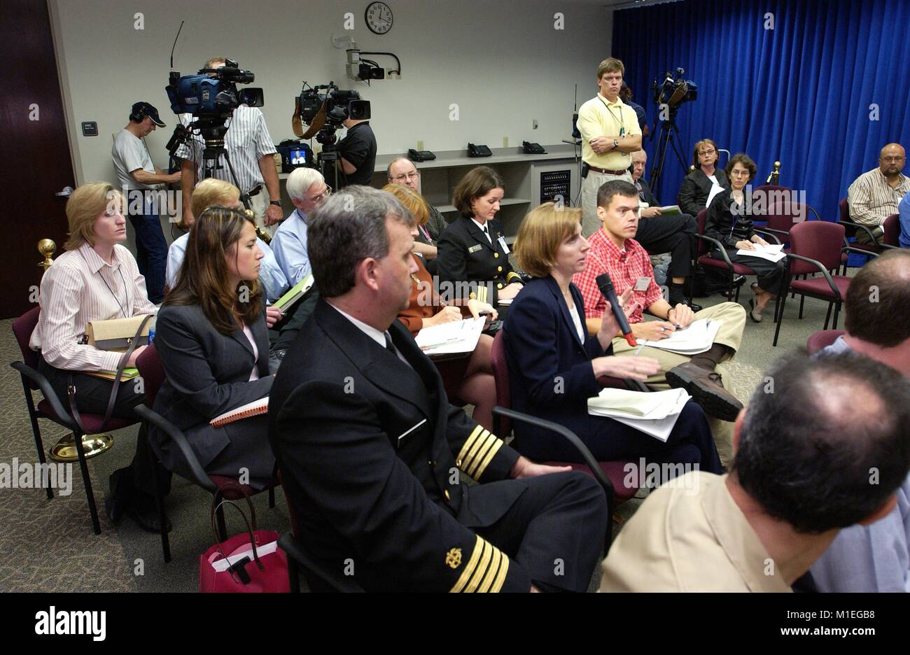 Photograph showing Wall Street Journal reporter Betsy McKay among other reporters seated at a CDC news conference, directing a question to the CDC director regarding current health threats, September 18, 2003. Image courtesy CDC. () Stock Photo