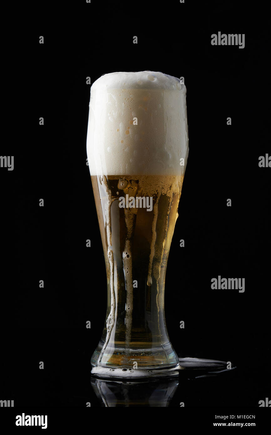 Wet full beer glass stand isolated on black background Stock Photo Alamy