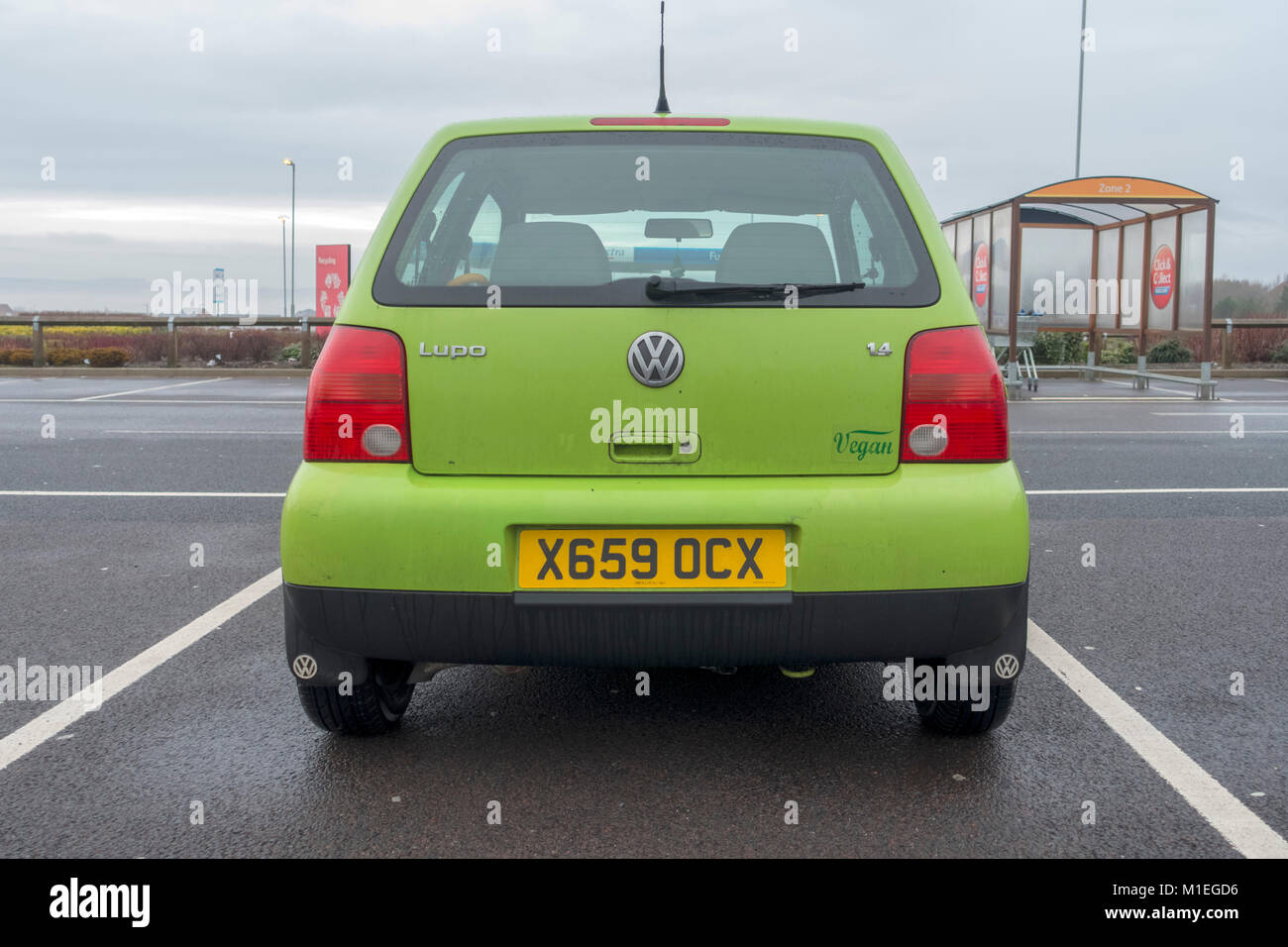 Small green Volkswagen Lupo car with Vegan sticker on the back Stock Photo