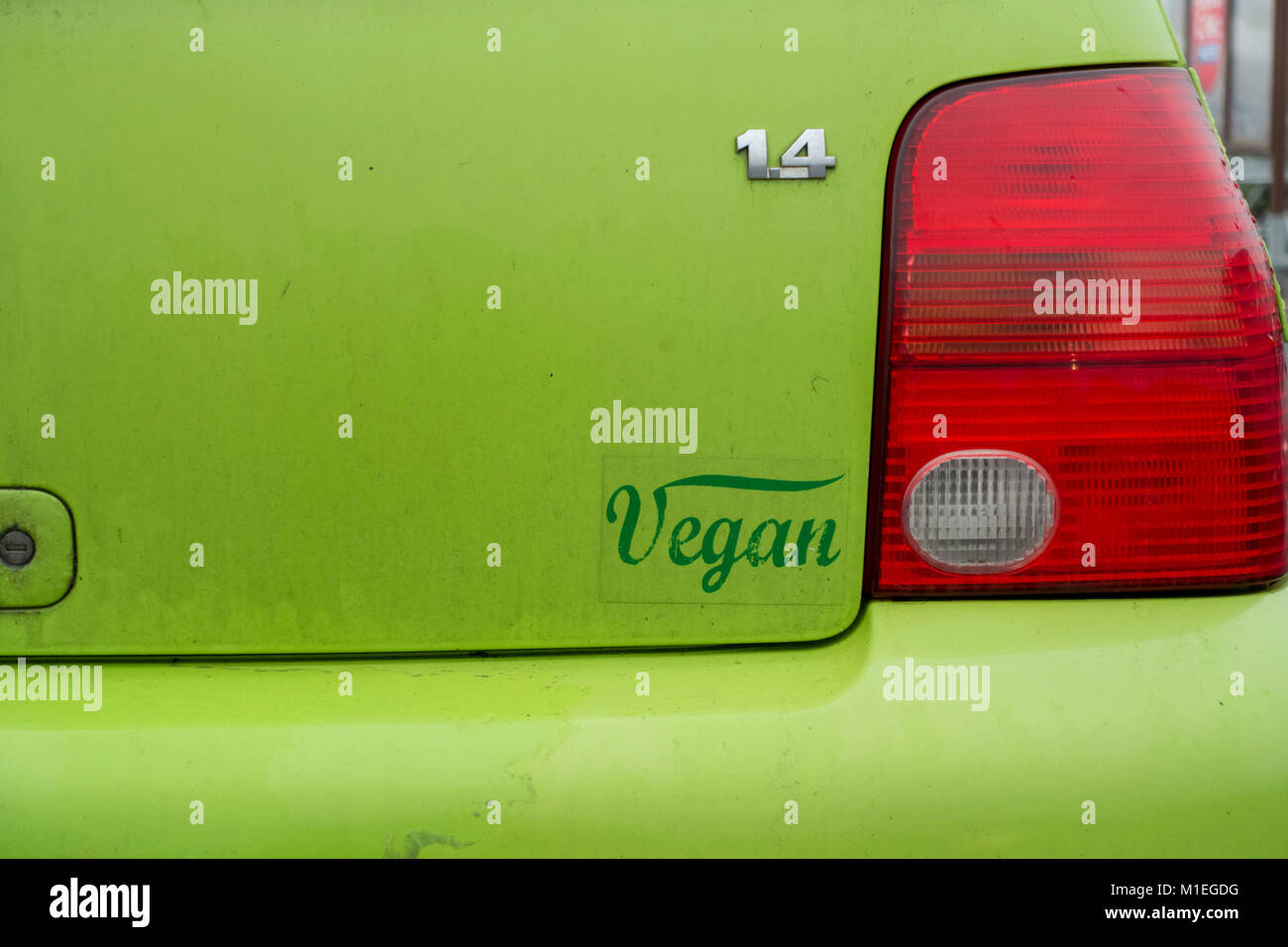 Small green Volkswagen Lupo car with Vegan sticker on the back Stock Photo