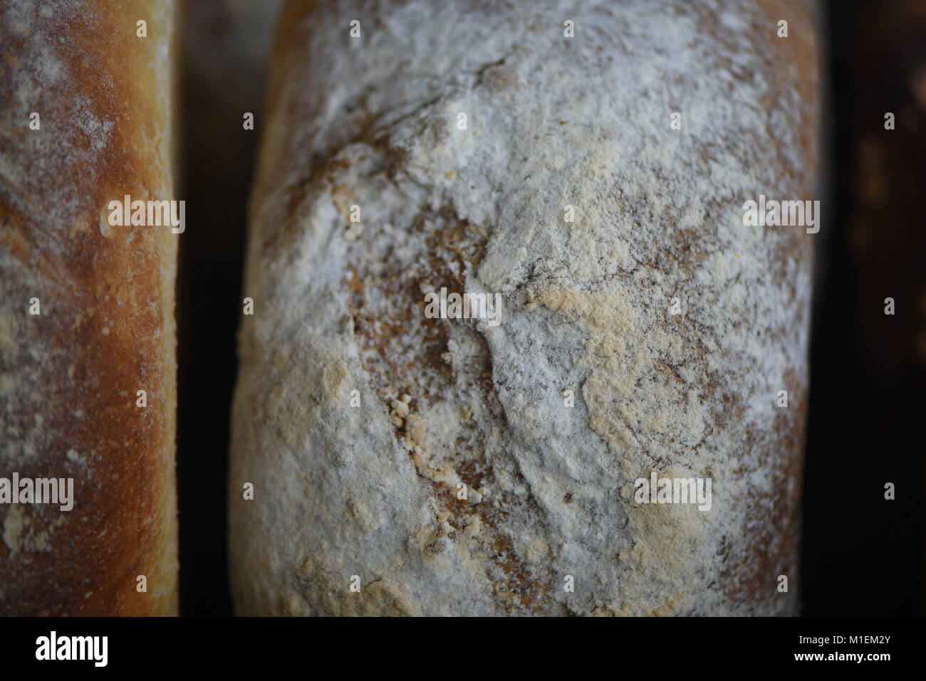 close up food of artisan white loaf of bread that has been home made and baked with dusted flour top Stock Photo