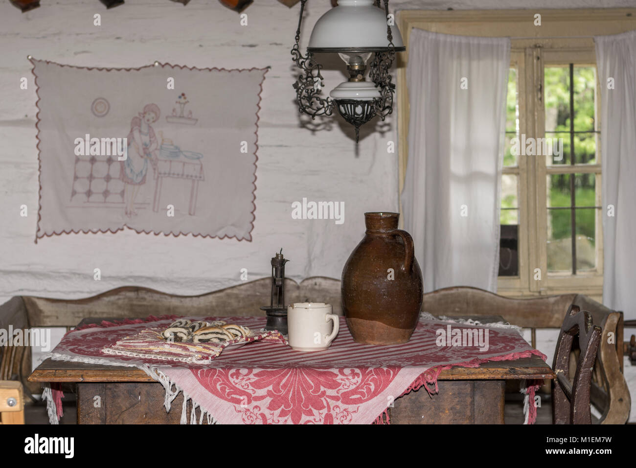 Traditional dining table with jar, mug and poppyseed rolls Stock Photo