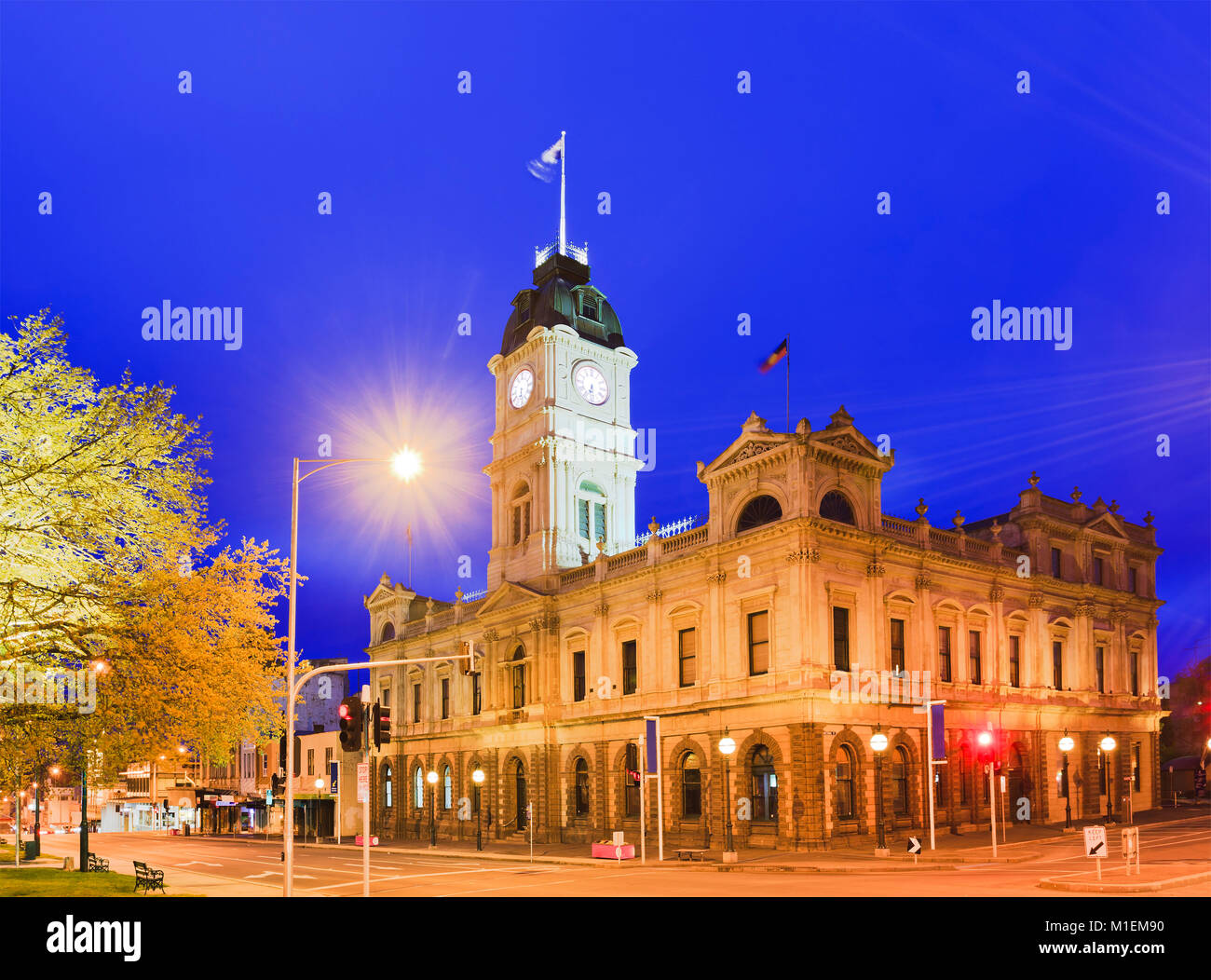 Town hall in regional town of Ballarat, Victoria. Sunrise agains blue sky with bright illumination of this historic architecture of gold rush region. Stock Photo