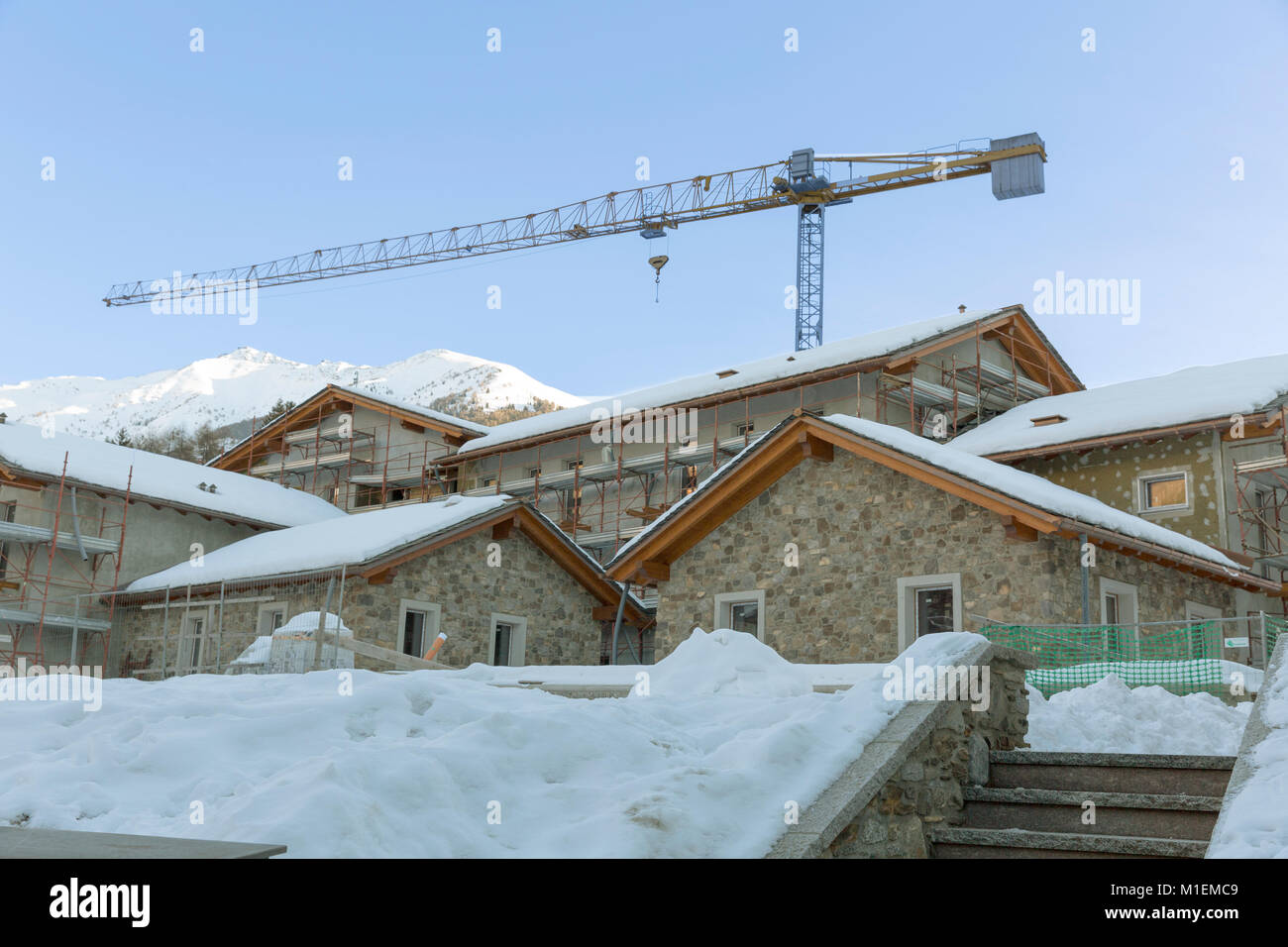 Construction of hotel or tourist apartment at ski resort in Italy, Alps
