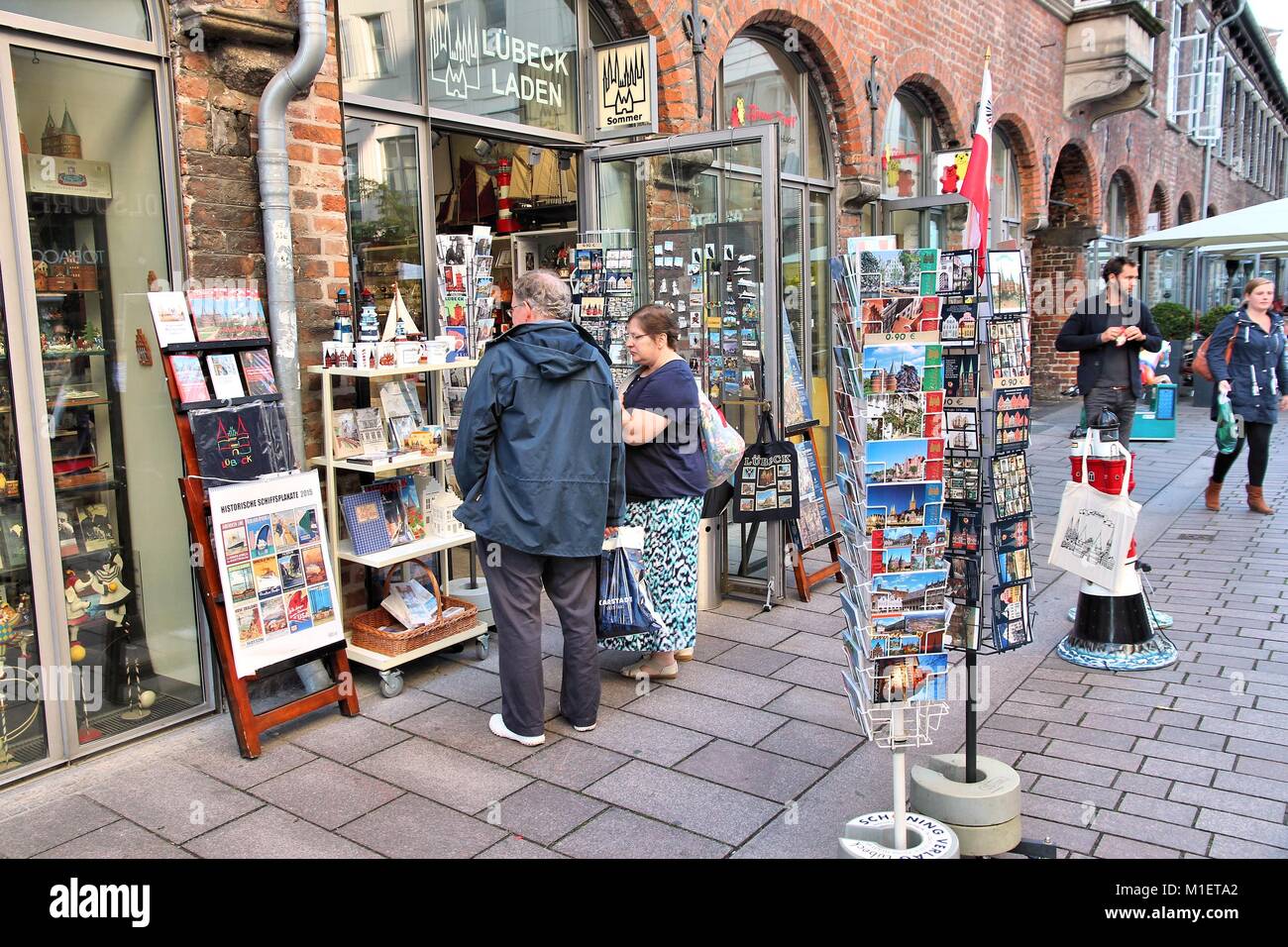LUBECK, GERMANY - AUGUST 29, 2014: People buy souvenirs in Lubeck, Germany. Lubeck is the 2nd largest city in Schleswig-Holstein region. Its old town  Stock Photo