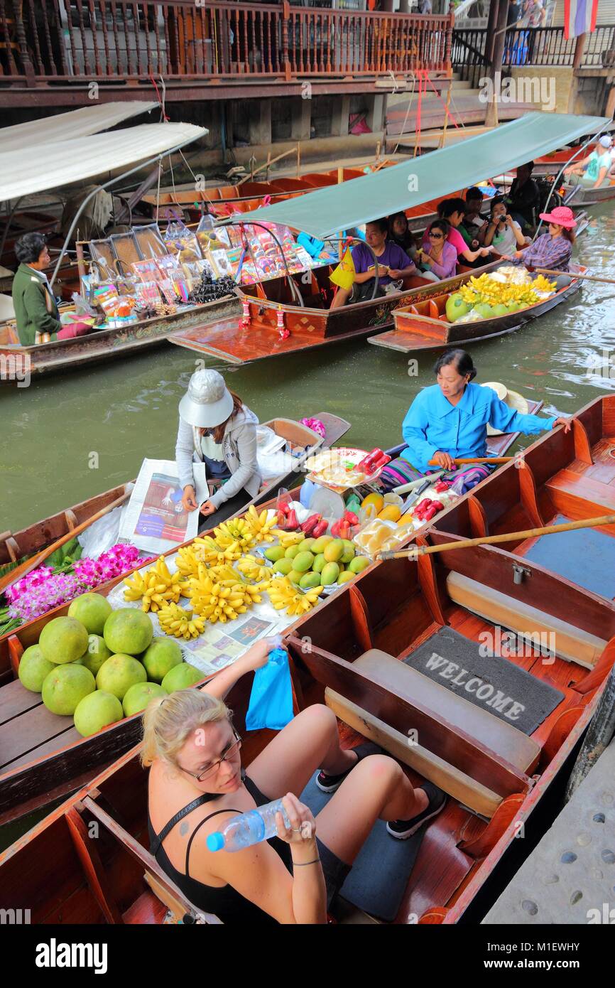 RATCHABURI, THAILAND - DECEMBER 24, 2013: People visit Damnoen Saduak floating market. Damnoen Saduak is the most popular floating market in Thailand. Stock Photo