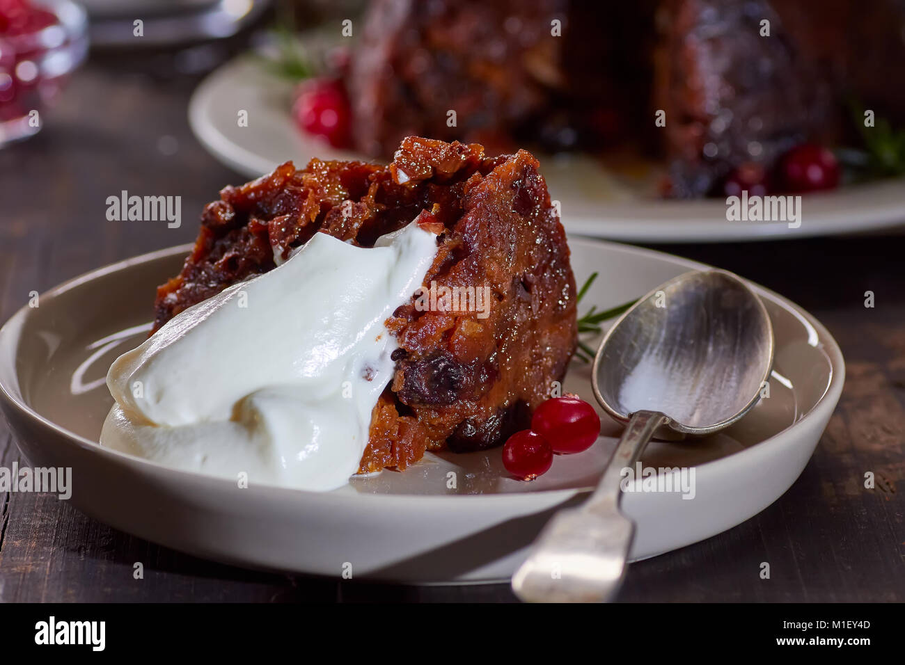 Piece of christmas pudding with whipped cream Stock Photo
