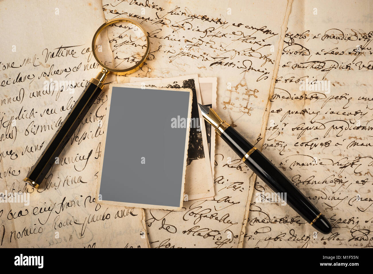 Images and letters with fountain pen and magnifying glass Stock Photo