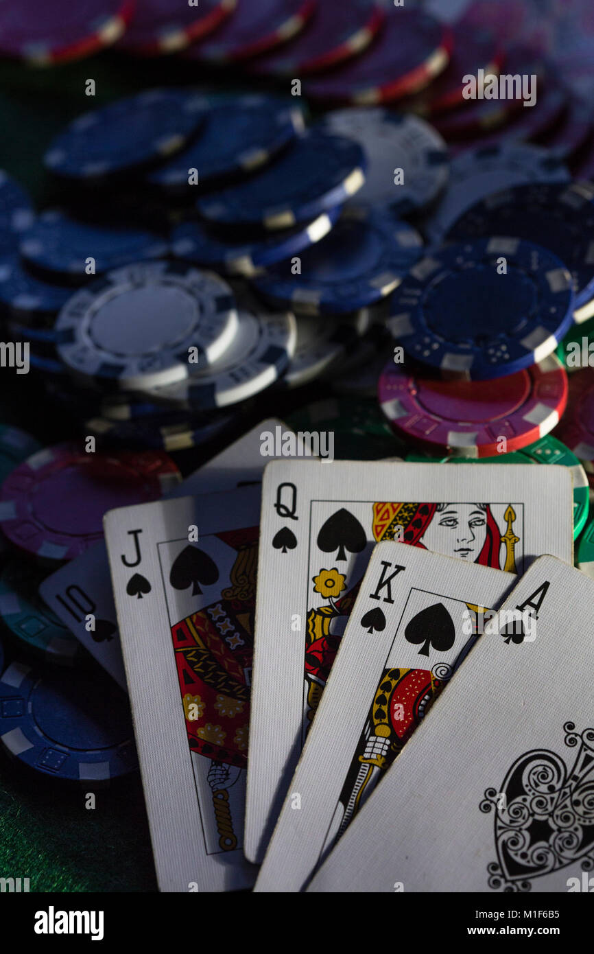 A green baize card table with chips and cards, stacks and piles of