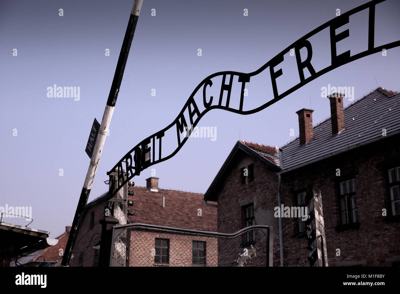 Entrance to Auschwitz I showing chilling iconic signage 'Arbeit Macht Frei' - Work Sets You Free Stock Photo