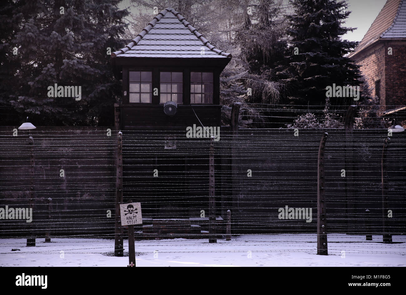 View inside Auschwitz I along electric fence, watchtowers and barbed wire . Stock Photo