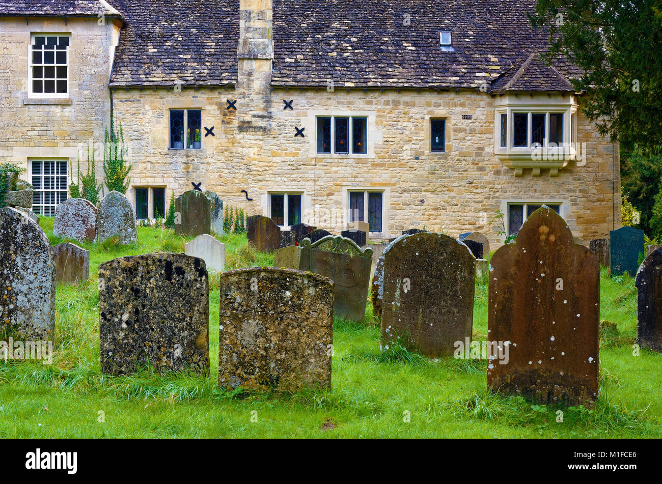 A view of St Michaels cemetery and manse in Withington, Gloucestershire, England, UK Stock Photo