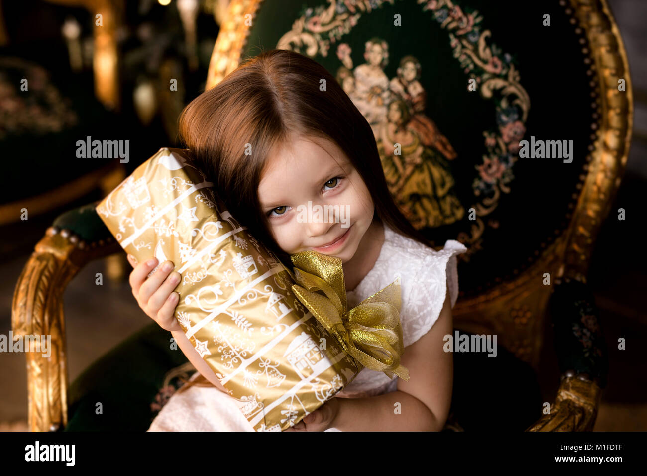 Happy little smiling girl with christmas gift box Stock Photo - Alamy