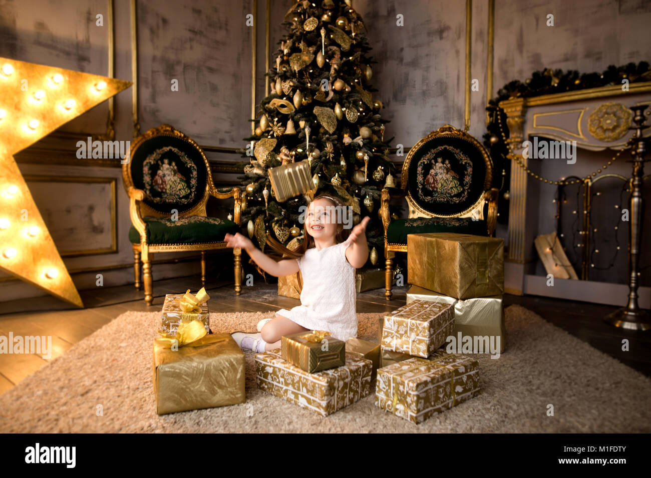 Happy little smiling girl with christmas gift box Stock Photo - Alamy