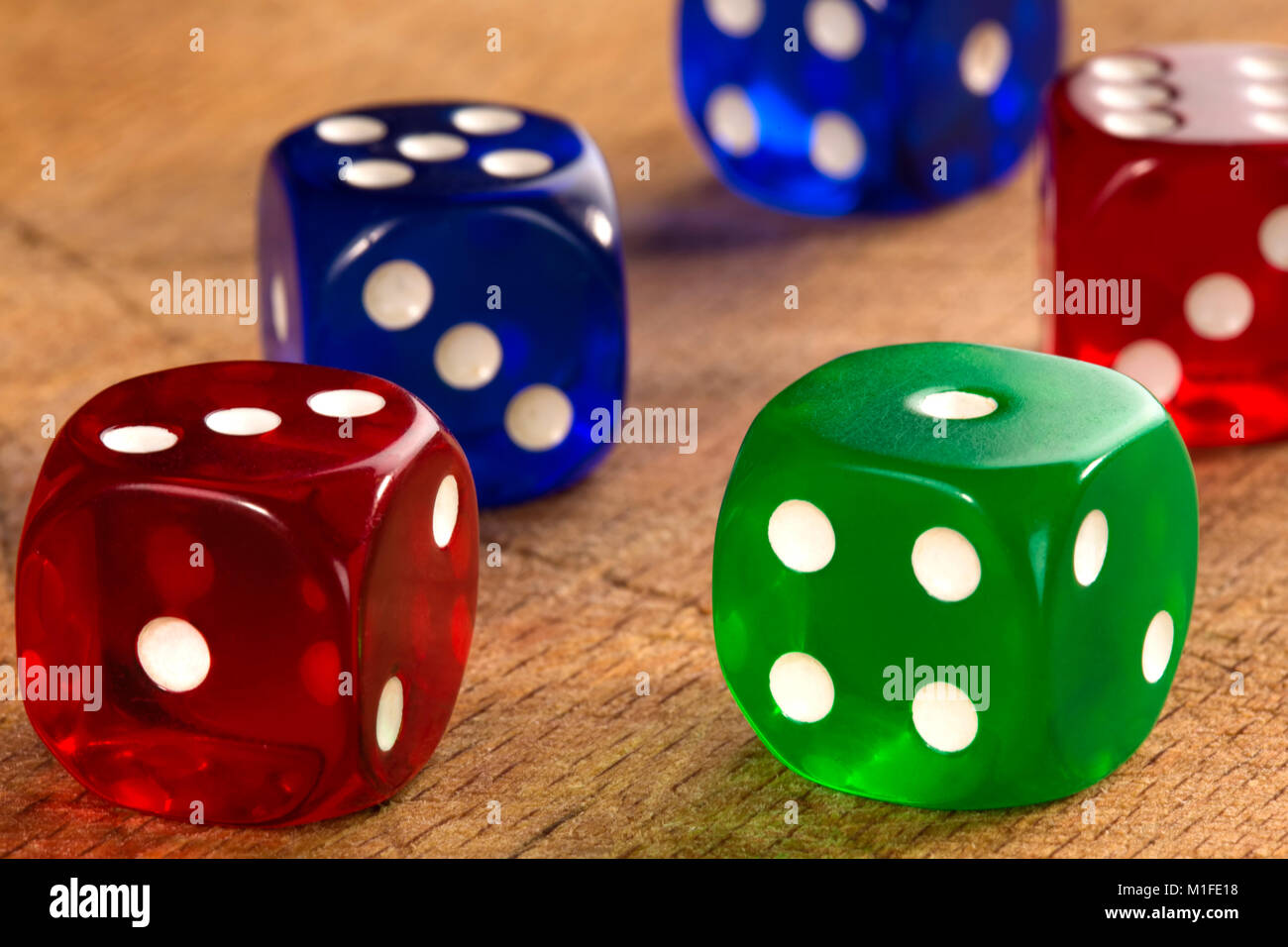 Close up of colorful dices background on wood background Stock Photo