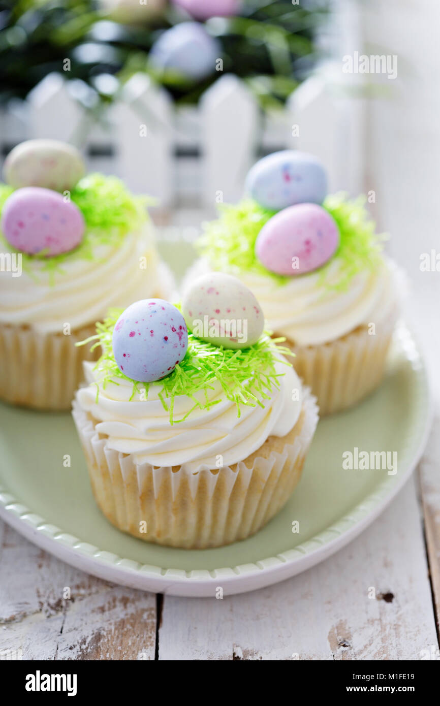 Easter vanilla cupcakes with cream cheese frosting and egg candy Stock