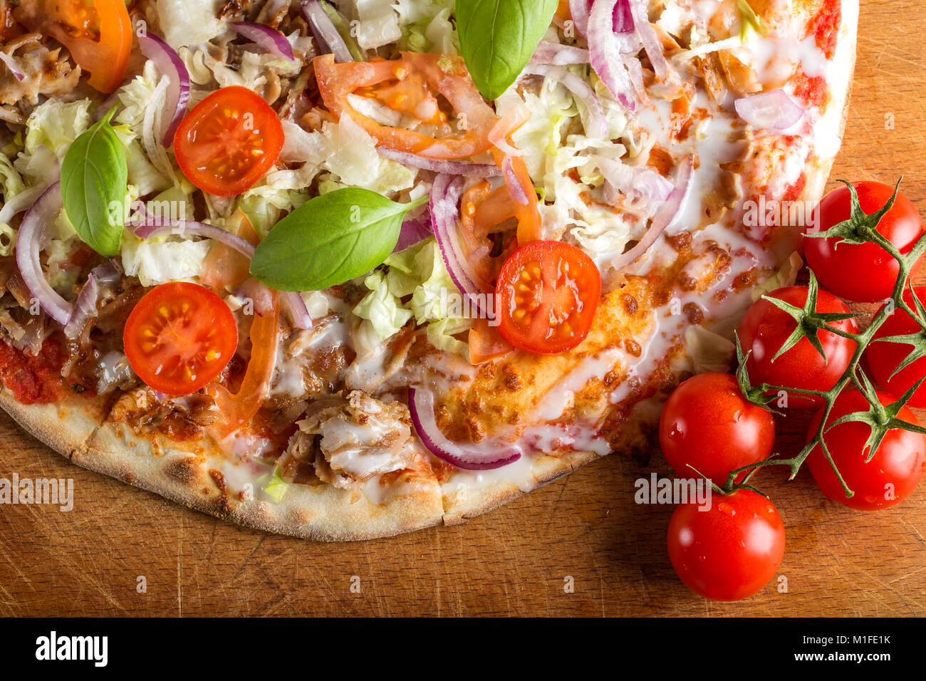 Close up of kebap pizza made with minced meat, cabbage, tomato and garlic sauce Stock Photo
