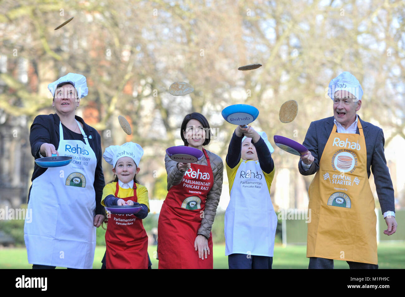 London, UK. 30th Jan, 2018. (L to R) Tonia Antoniazzi MP for the Parliament Team, and ITV News' Lucrezia Millarini for the Media Team, are joined by race veteran and this year's Official Starter, ITV newscaster, Alastair Stewart OBE, at a pancake race bootcamp in Westminster ahead of the main event, the Rehab Parliamentary Pancake Race, on Shrove Tuesday. They are joined by team mascots Grace and Jacob, both aged 8, from St Matthew's Primary School in Westminster. Credit: Stephen Chung/Alamy Live News Stock Photo