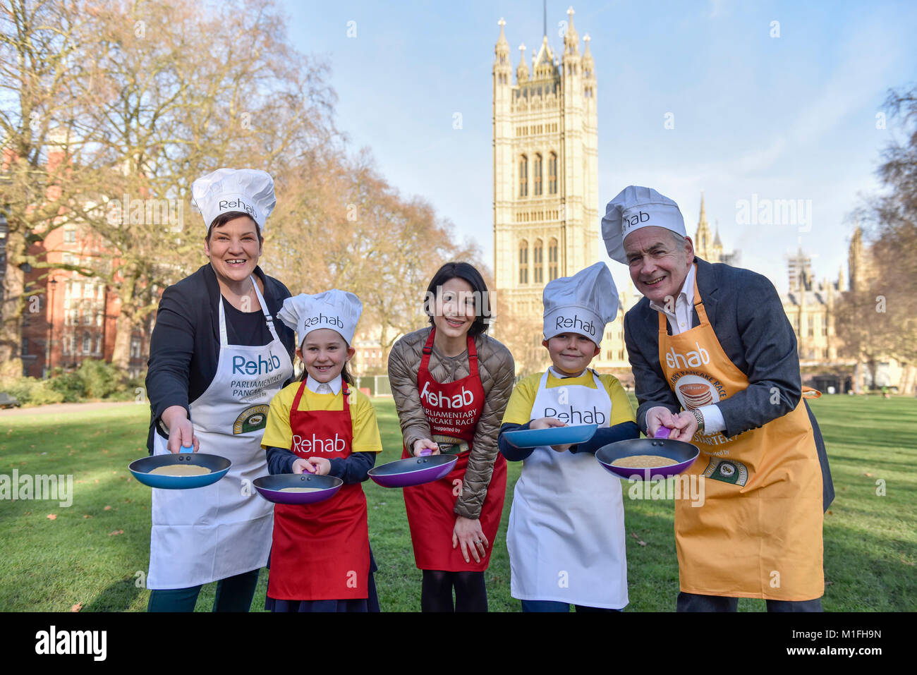London, UK. 30th Jan, 2018. (L to R) Tonia Antoniazzi MP for the Parliament Team, and ITV News' Lucrezia Millarini for the Media Team, are joined by race veteran and this year's Official Starter, ITV newscaster, Alastair Stewart OBE, at a pancake race bootcamp in Westminster ahead of the main event, the Rehab Parliamentary Pancake Race, on Shrove Tuesday. They are joined by team mascots Grace and Jacob, both aged 8, from St Matthew's Primary School in Westminster. Credit: Stephen Chung/Alamy Live News Stock Photo