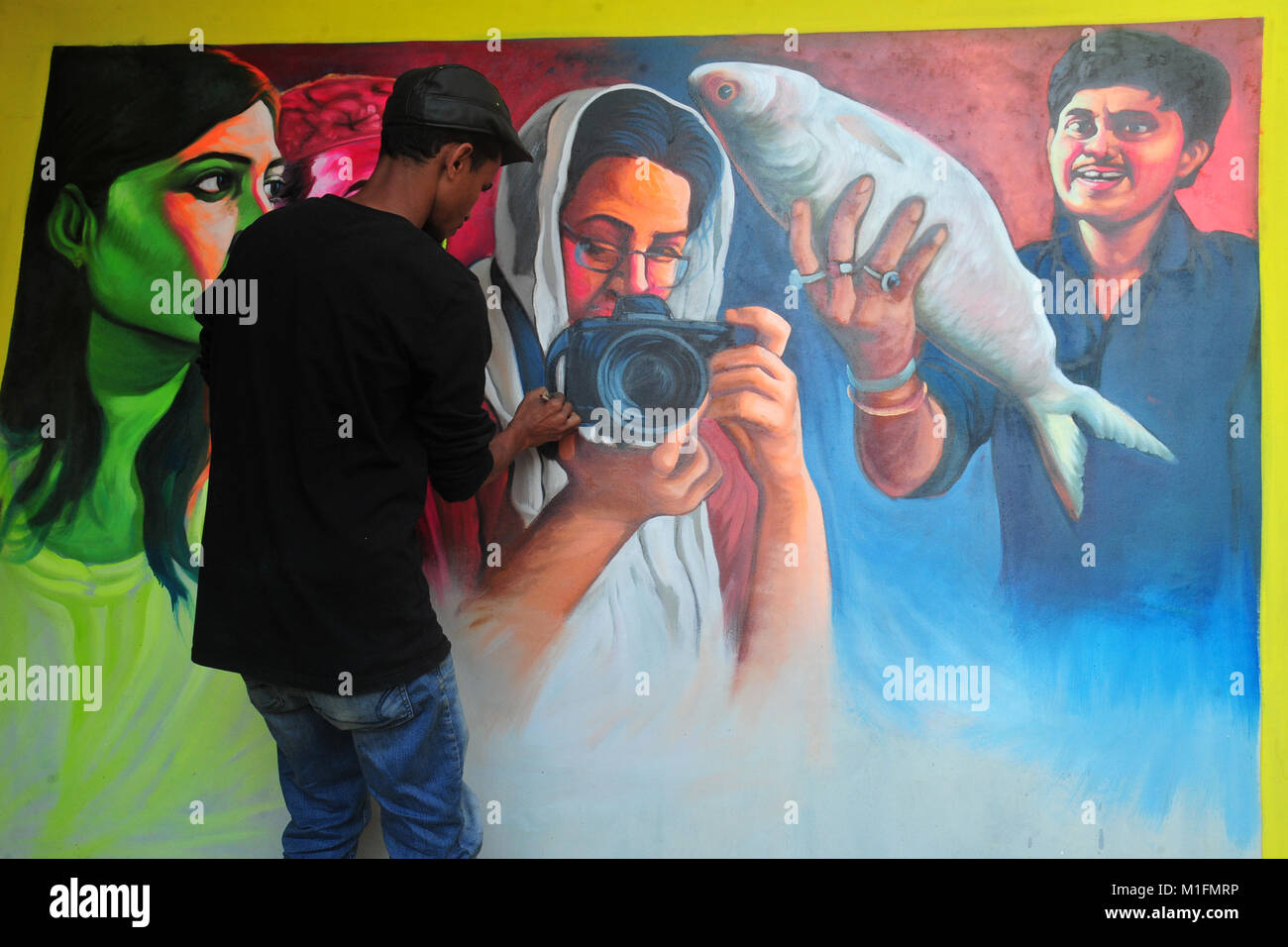 Bangladeshi artist drawing film banner at Old Town in Dhaka City, Bangladesh, on January 30, 2018. Film banner painting is one of the extinct arts works in Bangladesh. Stock Photo