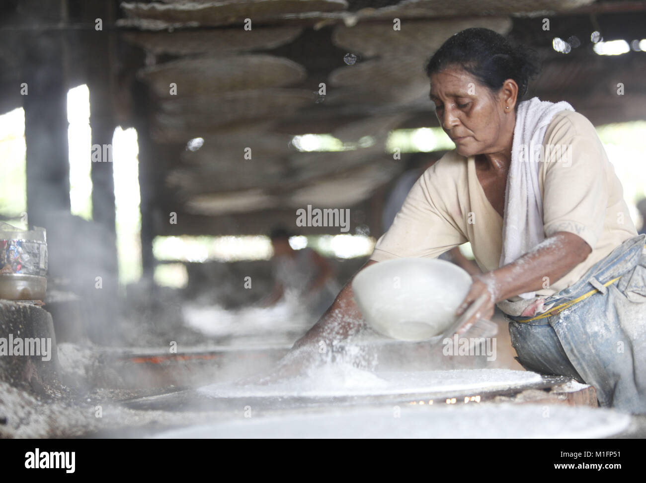 December 8, 2012 - Maturin, Monagas, Venezuela - december 09, 2012.A woman tends the nepe in the budare (flour made from bitter yucca) and the cooking of the cassabe begins.The casabe or cazabe is part of the tradition of the Venezuelan as its indigenous people elaborated it and it is known as the Venezuelan bread. In the city of Maturâ€™n, Monagas state. Venezuela .foto: Juan Carlos Hernandez (Credit Image: © Juan Carlos Hernandez via ZUMA Wire) Stock Photo