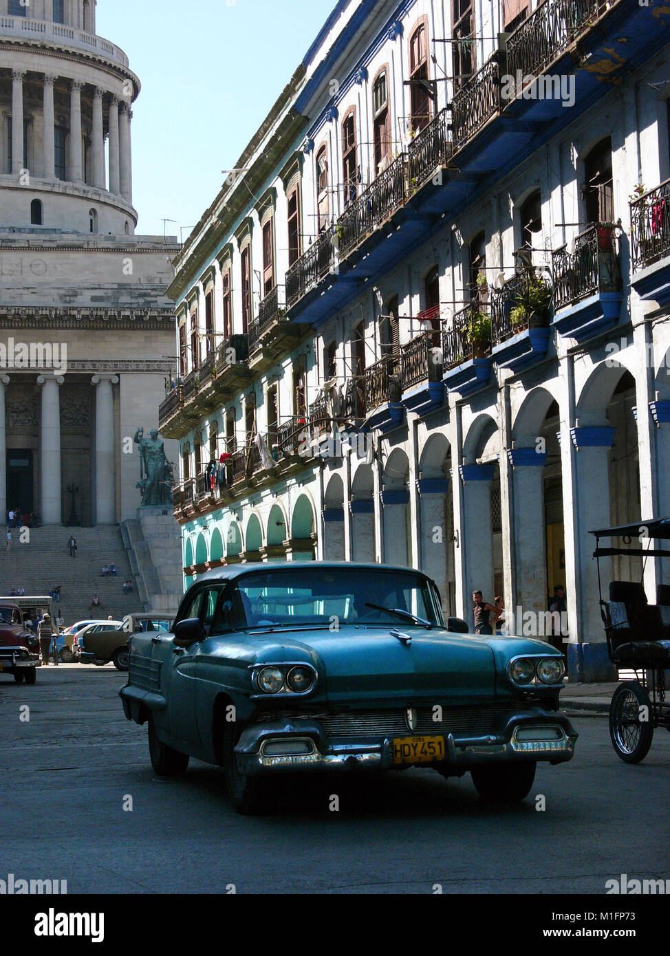 Feb 15, 2006; Havana, CUBA; One of many Cuban Maquinas, aka Yank tanks or pre 1960 American Classic cars in the streets of Havana with Capitolio Nacional (National Capitol building). One in eight cars in Cuba today is a pre-1960s American brand Ford, Chevrolet, Cadillac, Chrysler, Packard and other classic models. The Republic of Cuba is located in the northern Caribbean and south of the United States. The first European to visit Cuba was explorer Christopher Columbus in 1492. Centuries of colonial rule and revolutions followed. Batista was deposed by Fidel Castro and Che guevara in 1953. Aft Stock Photo