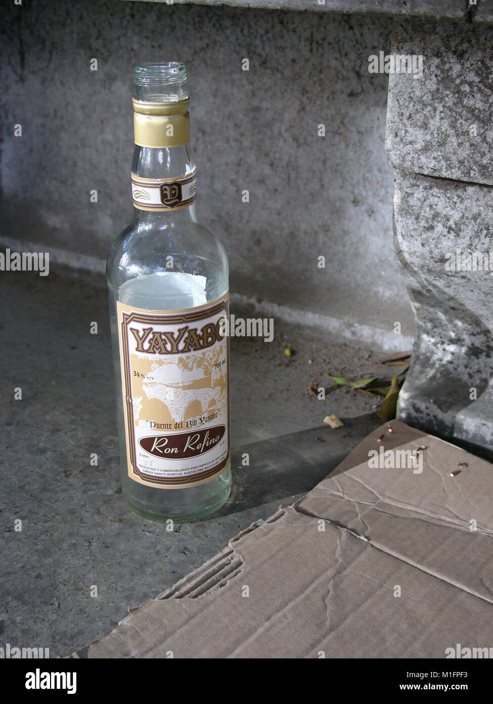 Mar 28, 2006 - Havana, CUBA - Empty bottle of Cuban rum sits next to a homeless persons cardboard box bed. The Republic of Cuba is located in the northern Caribbean and south of the United States. The first European to visit Cuba was explorer Christopher Columbus in 1492. Centuries of colonial rule and revolutions followed. Batista was deposed by Fidel Castro and Che guevara in 1953. After the revolution trade with comminist Russia grew. The economy was hit hard in the 1990s following the collapse of the Soviet Union. Cuba currently trades with almost every nation in the world, albeit with res Stock Photo