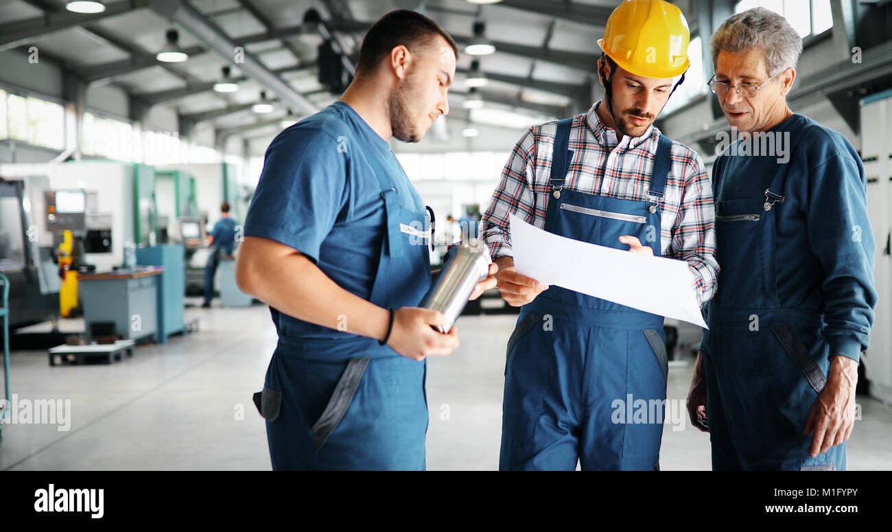 Team Of Engineers Having Discussion In Factory Stock Photo - Alamy