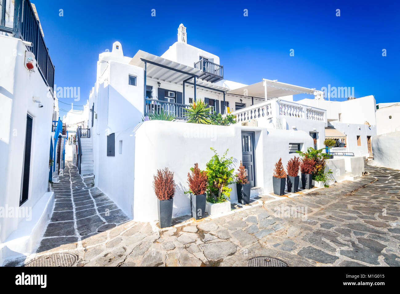 Mykonos, Greece. Whitewashed dotted alley in old city, Cyclades Greek Islands. Stock Photo