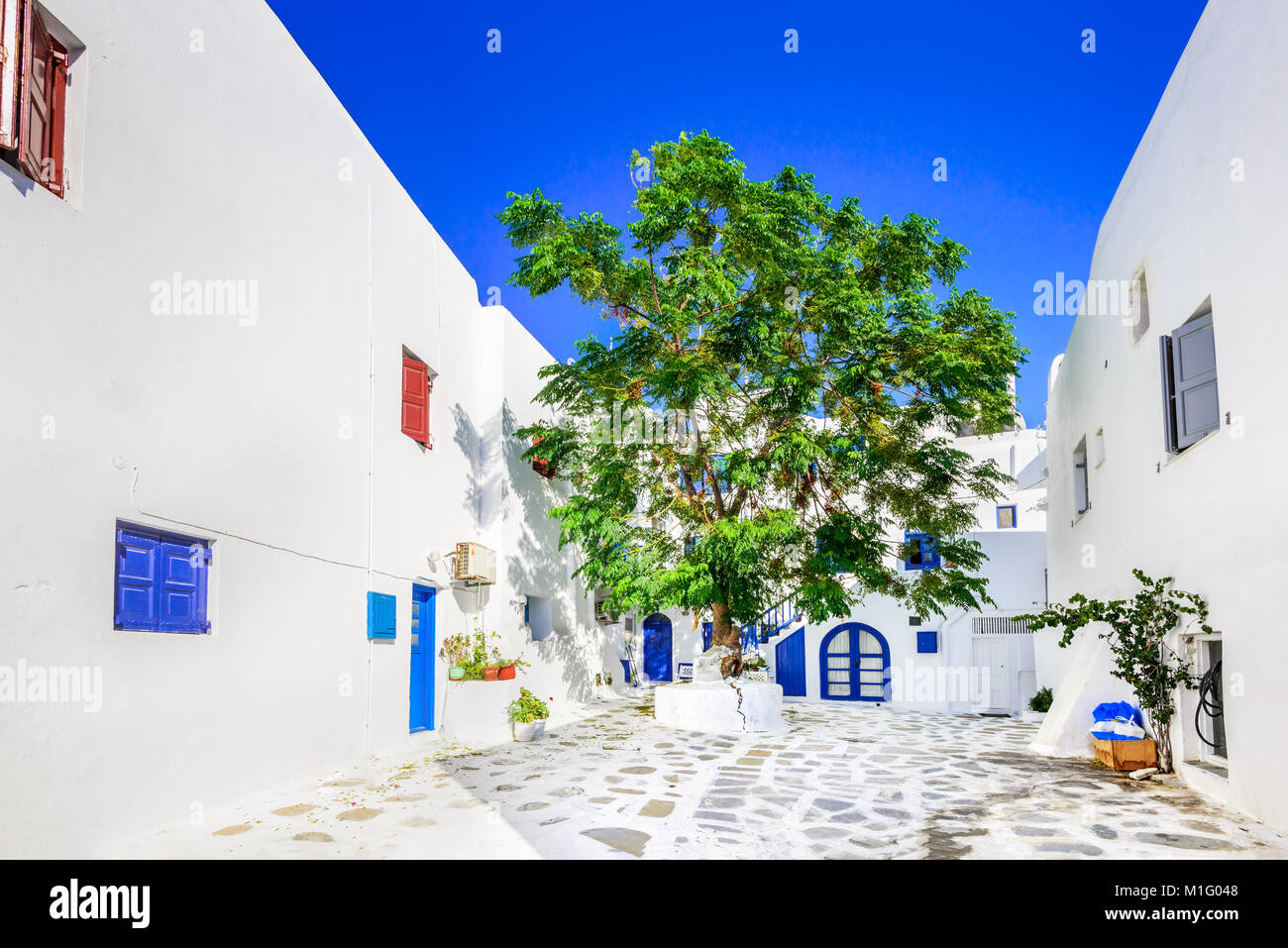 Mykonos, Greece. Whitewashed dotted alley in old city, Cyclades Greek Islands. Stock Photo
