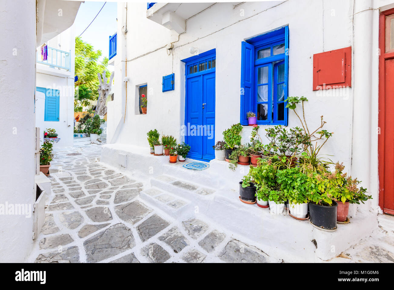 Mykonos, Greece. Whitewashed dotted alley in old city, Cyclades Greek Islands. Stock Photo