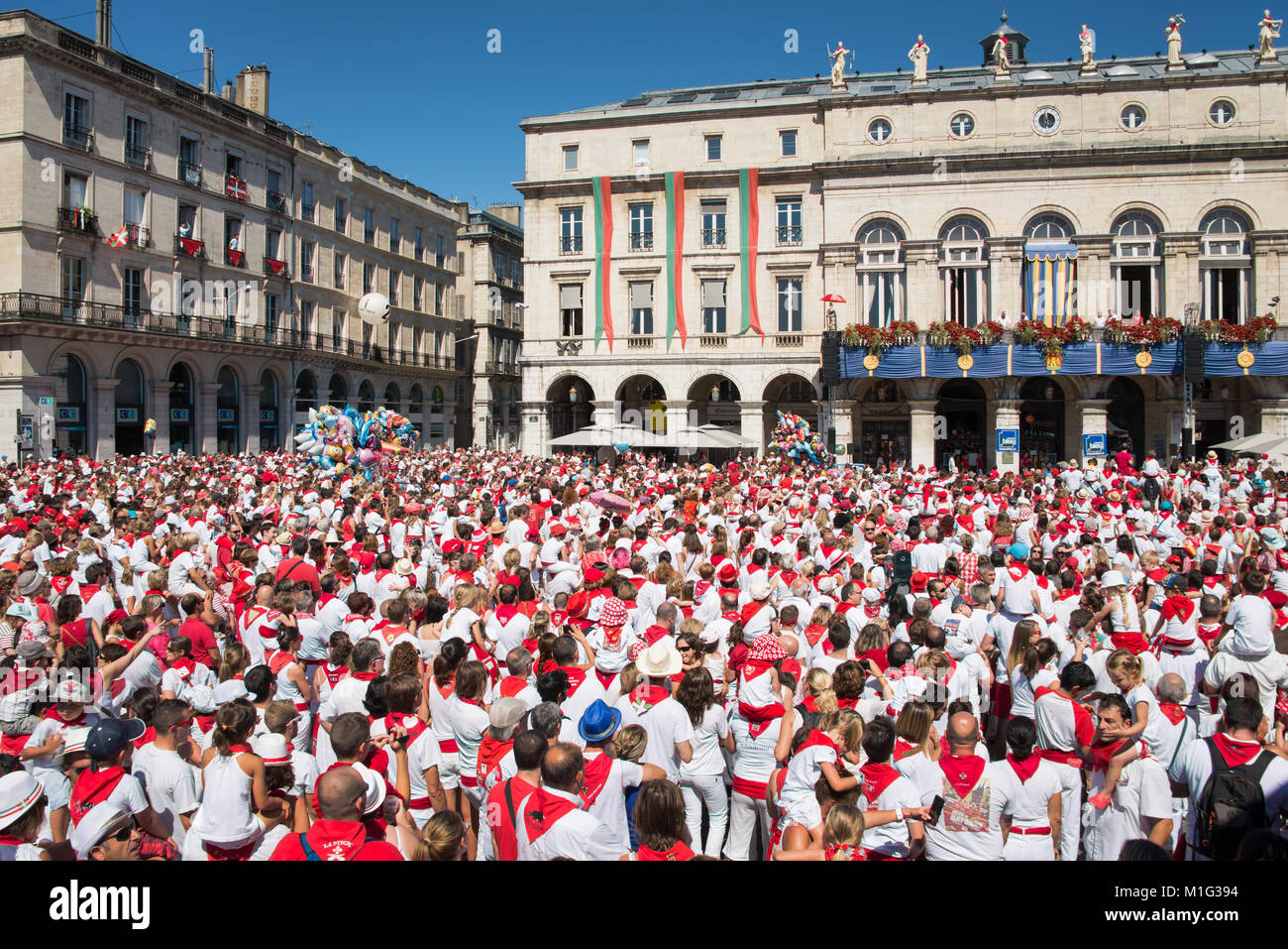 Crowd of people dressed in white and red at the Summer festival of Bayonne (Fetes de Bayonne), France Stock Photo