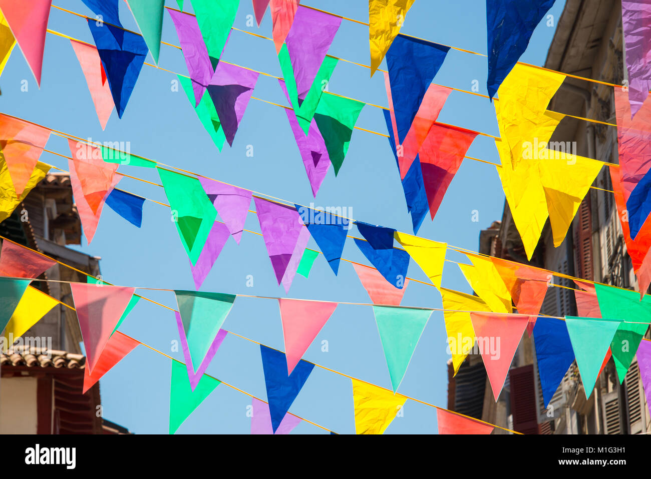 Colorful garlands decorating the streets of the city of Bayonne during the summer festival (fetes de Bayonne) in august Stock Photo