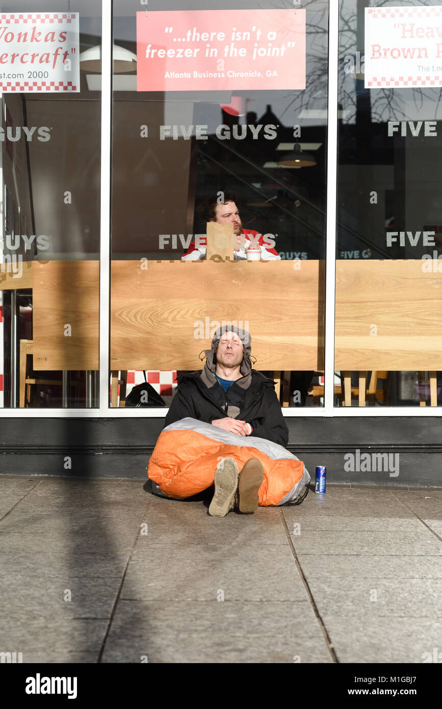 Homeless Man Outside Fast Food Restaurant In Nottingham,UK Stock Photo