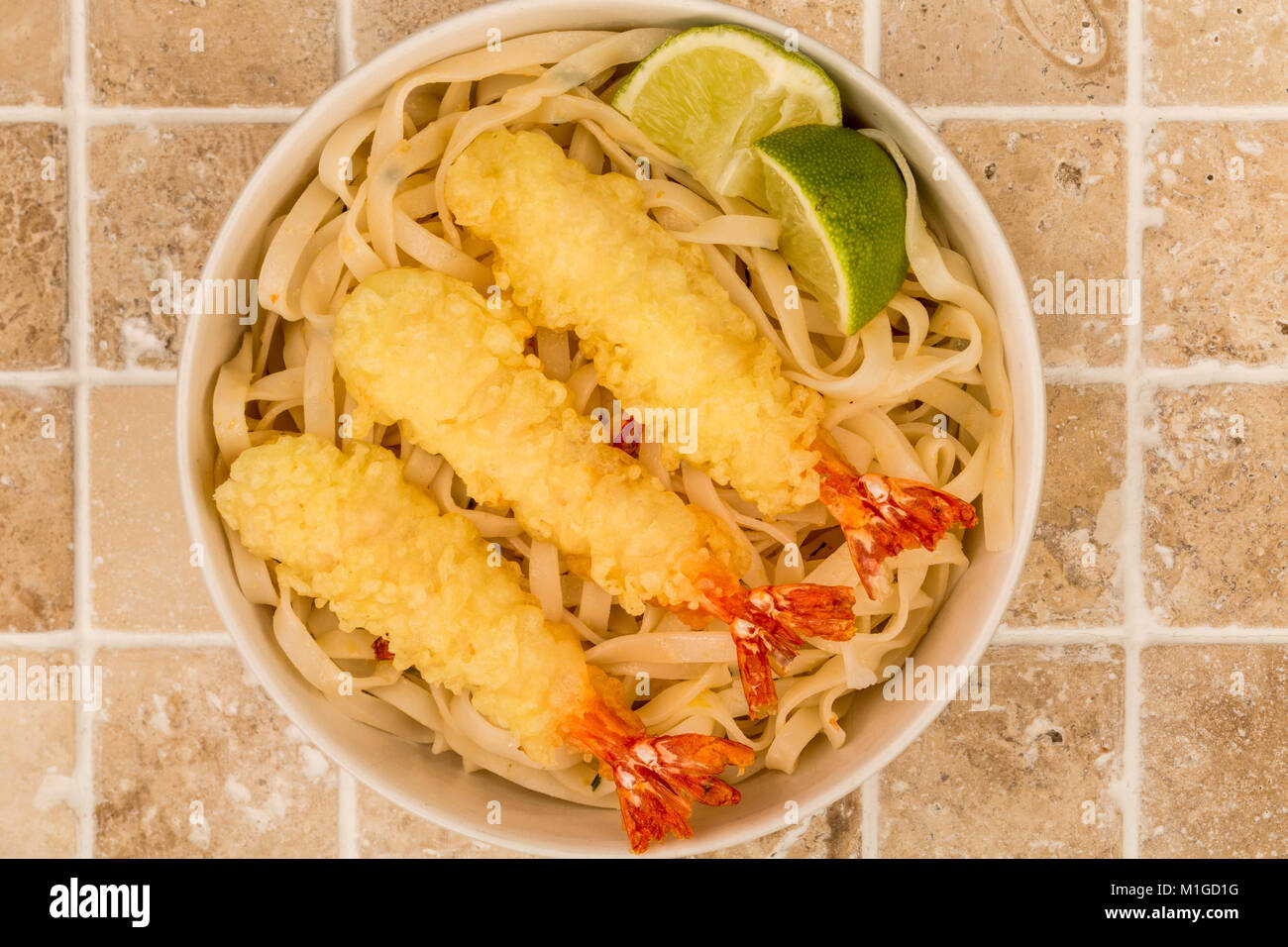 Japanese Style Deep Fried Prawn Tempura With Noodles and Lime Against A