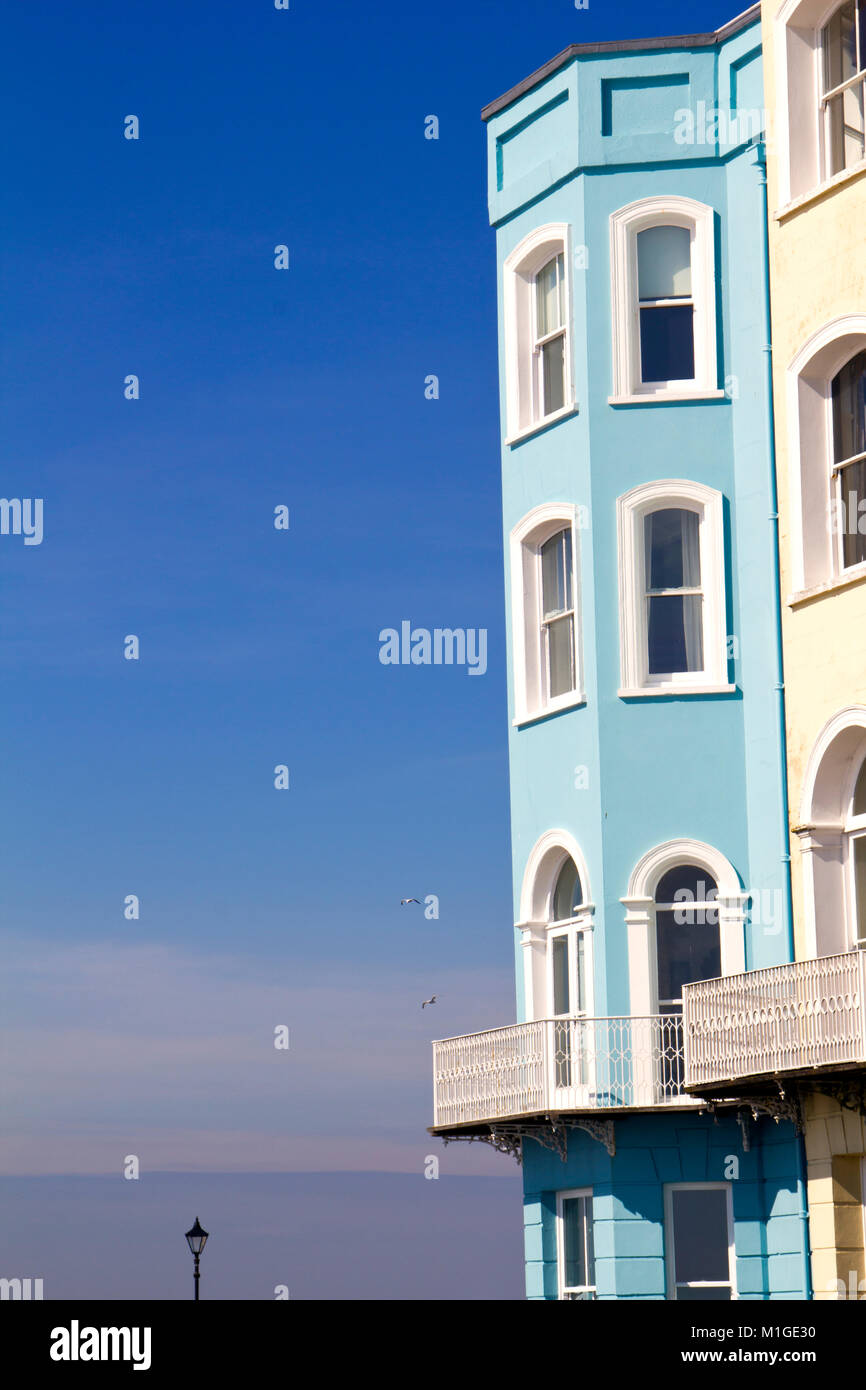 Colourful hotel frontages against a vibrant blue sky in Tenby, Pembrokeshire, Wales, UK Stock Photo