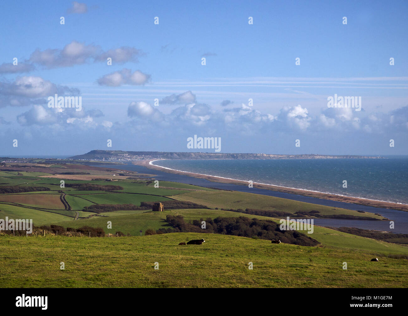 View of Chesil Beach in late afternoon sun, looking east towards Portland and 14th century St Catherine's chapel, Dorset, UK Stock Photo