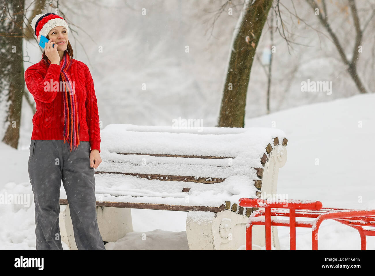 Attractive woman talking on the phone under the snow Stock Photo