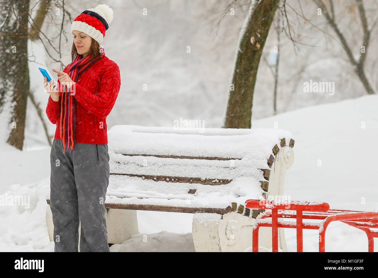 Attractive woman talking on the phone under the snow Stock Photo